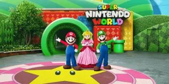 An artist rendering of Mario, Luigi and Princess Peach standing in front of the entrance to Super Nintendo World at Universal Studios Hollywood
