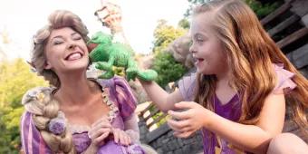 Rapunzel in the Magic Kingdom Park Rapunzel with a child playing with plush toy in the Magic Kingdom Park