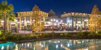 Raglan Road pub lit up at night on the other side of the water at Disney Springs