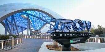 TRON Lightcycle/Run The TRON Lightcycle/Run sign with the ride and large futuristic canopy overhead