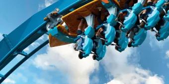 A close-up image of riders on a coaster at the point of inversion