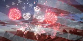 Fourth of July People watching fireworks covered by a faded image of an American flag