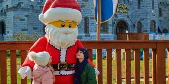 Christmas at LEGOLAND Windsor A boy and a girl looking up at LEGO Santa