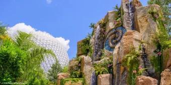 Journey of Water, Inspired by Moana at EPCOT A rock formation with the Heart of Te Fiti at its centre with Spaceship Earth in the background