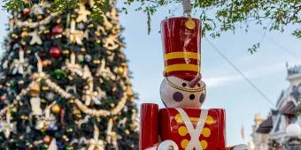 A toy solder in front of a giant Christmas tree 