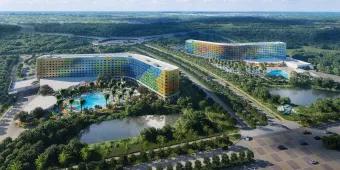 Concept art of two curve-shaped hotels next to each other with multi-coloured panelling 