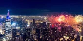 New York City skyline with many fireworks being launched over the city