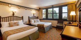 Disney Sequoia Lodge at Disneyland Paris A forest/Bambi themed hotel room with two beds, a chair and a dresser
