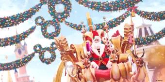 Santa on top of a parade float in front of Sleeping Beauty Castle at Disneyland Paris