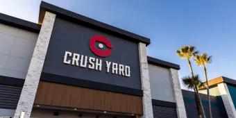 A building which looks new and modern with a sign saying Crush on it and a paddleboard logo. Yard