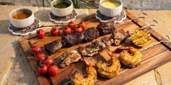 Shish Kebabs at Universal Helios Grand Hotel A selection of shish kebabs and dips on a wooden serving board