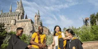 A family posing outside Hogwarts Castle in Universal Orlando Resort