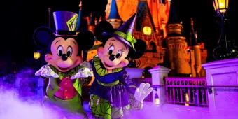 Mickey's Not-So-Scary Halloween Party Mickey and Minnie Mouse in Halloween costumes standing in front of Cinderella Castle