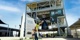 The Gantry at LC-39 A woman and young girl standing in front of a rocket experience at Kennedy Space Center