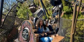 Happy riders experiencing the high-speed twists of Hagrid's coaster, illustrating a top attraction where a Universal Express Pass is vital for saving time and skipping long Orlando theme park queues.