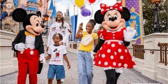 Mickey Mouse, Minnie Mouse, and a family walking in front of a Disney castle