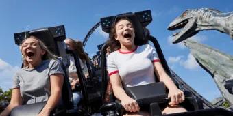 Guests laughing and screaming with excitement on the Jurassic World VelociCoaster at Universal Orlando Resort, one of the top attractions in Orlando.