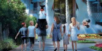 A family walking toward the Swan and Dolphin Resort fountains at Walt Disney World.