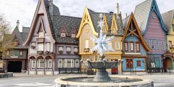 Arendelle-style buildings surround a crystalline snowflake fountain at Disneyland® Paris