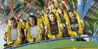 Four people on a roller coaster at PortAventura World