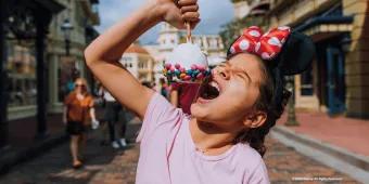 Guest on Main Street, U.S.A. eating a snack
