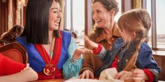 Mulan interacting with a mother and young girl during character dining at The Regal View Restaurant & Lounge