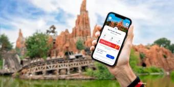 A person holding a phone up with Disney Premier Access on the screen