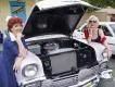 Old Town Classic Car Show Two women wearing vintage clothes and make-up leaning on a classic car