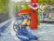 Hydra's Challenge A woman and child getting splashed in a boat ride vehicle in front of a giant Lego sea serpent