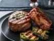 Steak in Orlando Two steak filets on a plate with grilled green vegetables