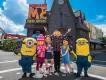 The Minions at Universal Studios Florida Characters from Despicable Me, including two Minions and Gru, standing outside Despicable Me Minion Mayhem