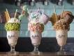 New Restaurants Coming to Orlando Three large milkshakes in a row topped with whipped cream, sprinkles, marshmallows and cookies