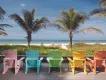 Anna Maria Island A row of different coloured beach chairs looking out onto the beach