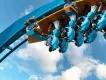 Pipeline: The Surf Coaster A close-up image of riders on a coaster at the point of inversion