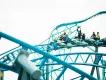 Arctic Rescue at SeaWorld San Diego People riding a coaster with ride vehicles shaped like snowmobiles on a blue track