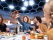 Dining at PYM Kitchen A child holding up a giant pretzel while sat at a table eating food with his two parents and sibling
