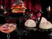 Food and Drink at Halloween Horror Nights 2023 Snowball cakes, a double cheeseburger with a red bun and a cocktail against a black and red background