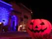 Halloween at Dubai Parks & Resorts A jack-o'-lantern on the ground in front of a stone building at night