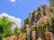 Journey of Water, Inspired by Moana at EPCOT A rock formation with the Heart of Te Fiti at its centre with Spaceship Earth in the background
