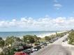 Florida Beaches A view down a road running along a white sandy beach and blue ocean