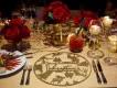 Christmas Dining in Orlando A table decorated for Christmas with red flowers and gold place settings