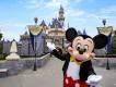 Disneyland Resort in California Mickey Mouse standing in front of Sleeping Beauty Castle at Disneyland Resort