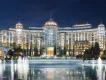 Universal Helios Grand Hotel Large white building with rounded shape around large fountains. On top there are circular details on the roof that are golden with turquoise spikes on top. Looks very modern.