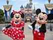 Disneyland Resort in California Mickey and Minnie Mouse posing in front of Sleeping Beauty Castle at Disneyland Resort