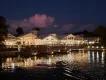 Disney's Old Key West Beautiful white building lit up at night with yellow lighting. It is overlooking a huge lake.