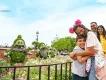 Springtime in Walt Disney World Resort A boy and girl hugging next to topiaries of the seven dwarves from Snow White