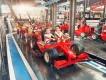 Ferrari World, Yas Island Small kids sat on rollercoaster car which is shaped like a red Ferrari Formula 1 car