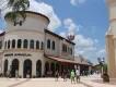 Under Armour in Disney Springs Under armour large white store with a hot air balloon floating in the air behind. There is also a large open walkway which people are using.