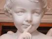 Cupid supporting revenge on an ex Statue of cupid (young boy) holding finger to lips as if to say shhhh with a mischevious expression