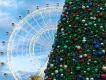 The orlando eye with a christmas tree in front of it.
